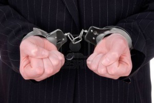 2115526-business-person-in-suit-in-handcuffs